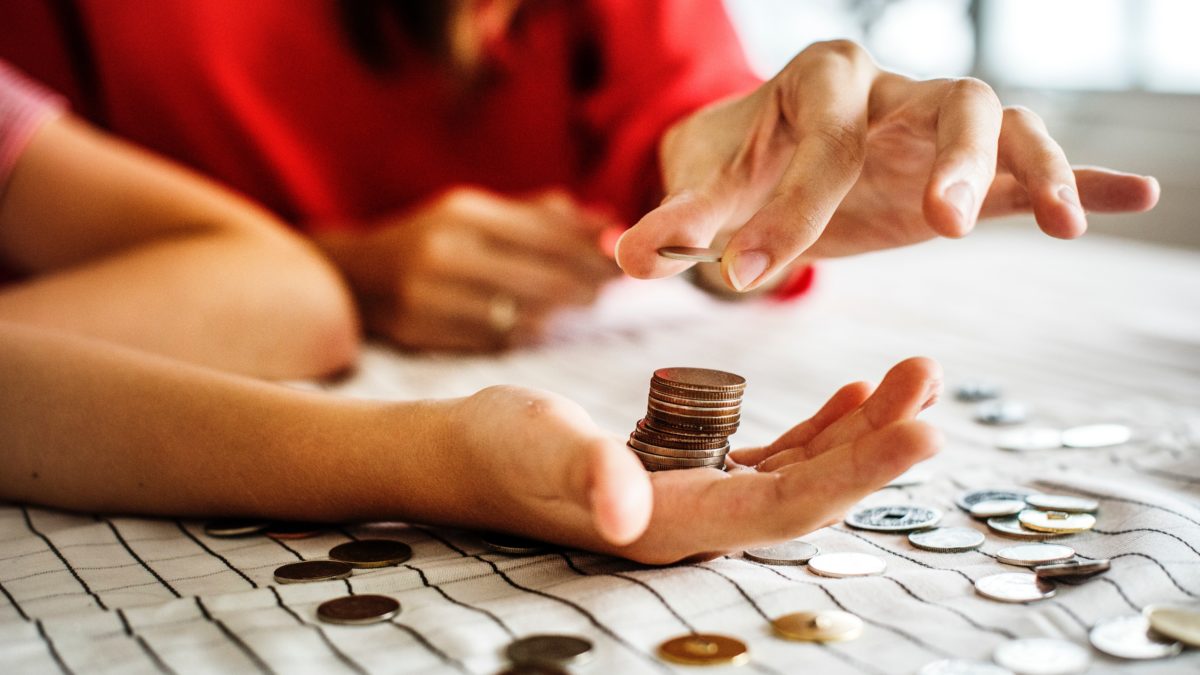 women counting pennies in her hand